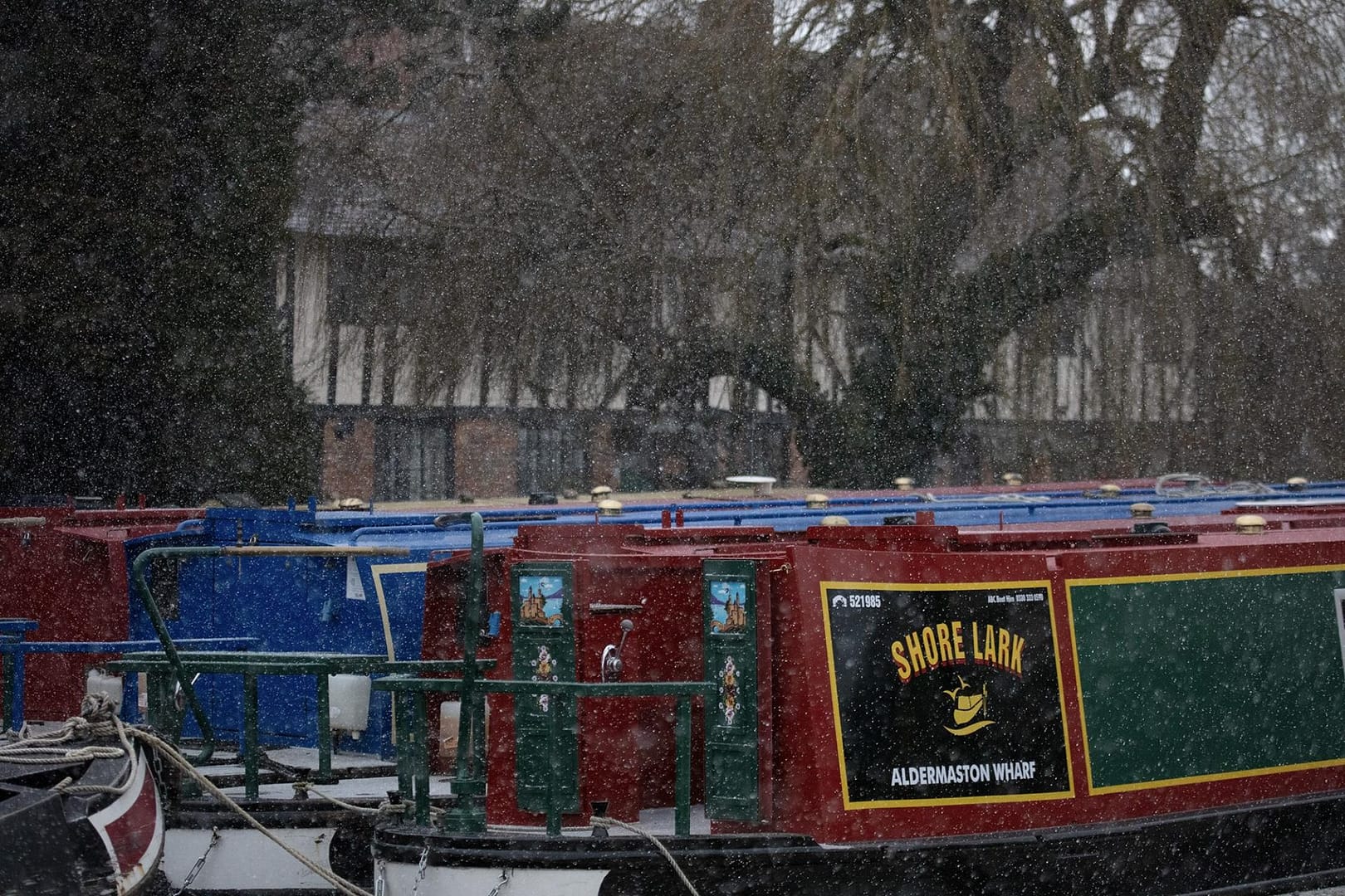 Barges moored up with snow falling