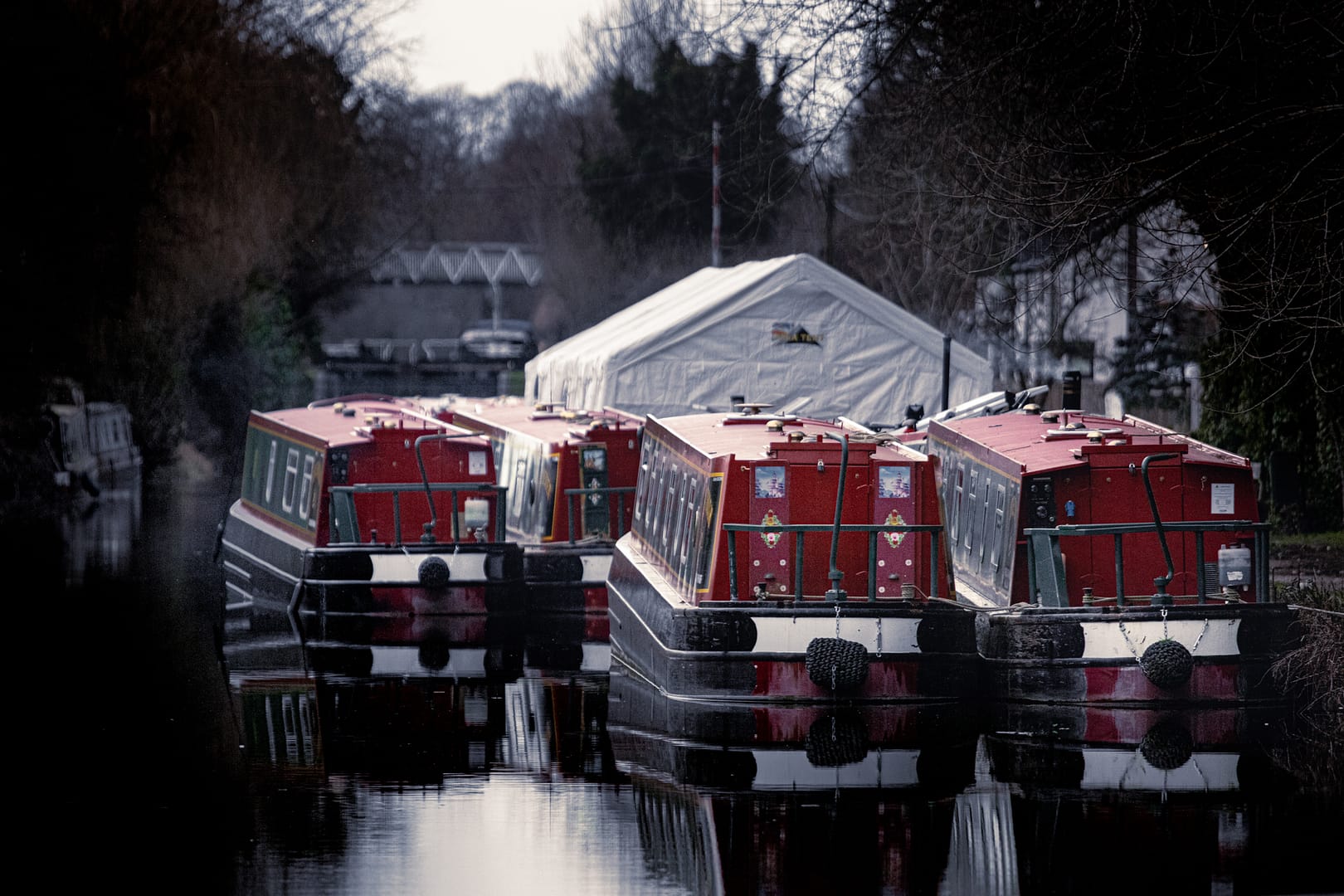 Red Narrow Boats moored up at Aldermaston Wharf