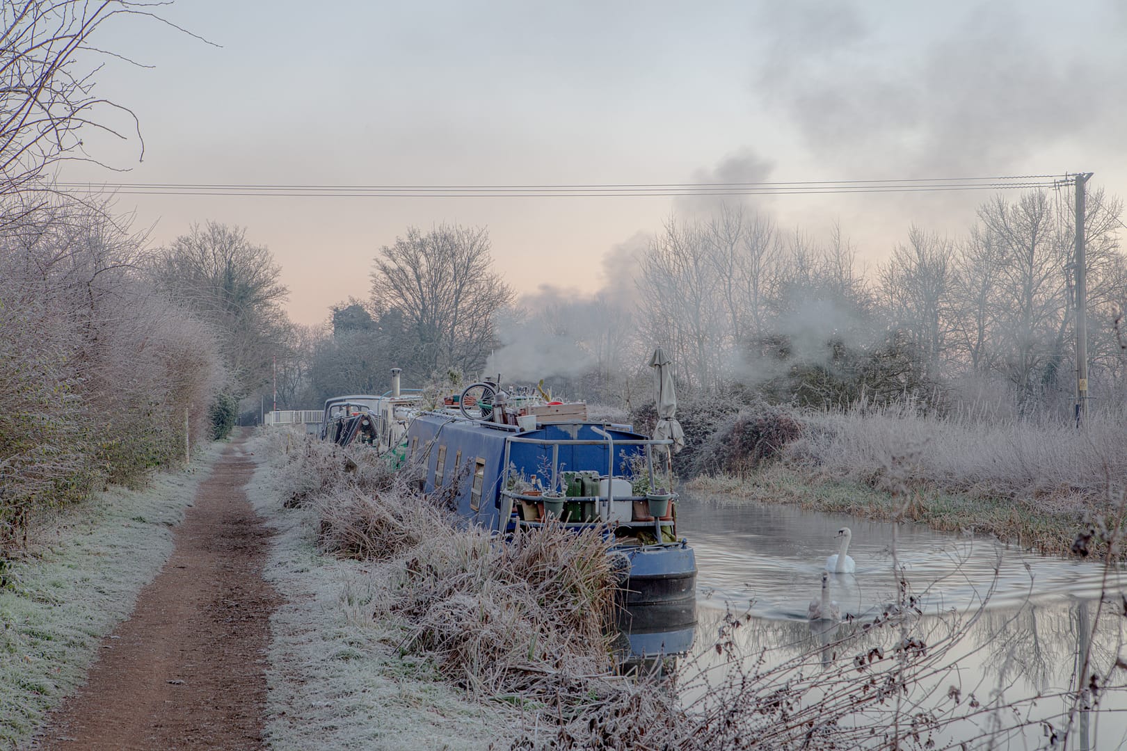 Aldermaston Wharf Winter on the Kennet and Avon Canal. Frost covers the narrow boats.