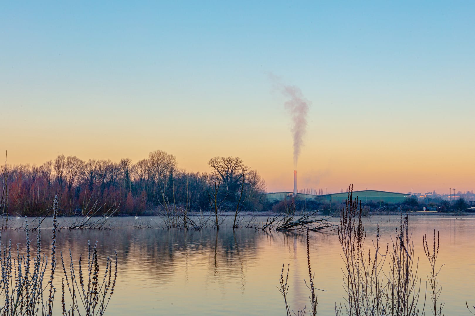 Dawn looking over the waters near Aldermaston Wharf. Winters day highlights the industrial area just passed the canal.